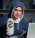 Young hacker hacking into computer at night Royalty Free Stock Photo