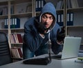 Young hacker hacking into computer at night Royalty Free Stock Photo