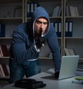 Young hacker hacking into computer at night Royalty Free Stock Photo