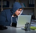Young hacker hacking into computer at night Royalty Free Stock Photo