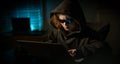 Young hacker with hood and glasses at night. Child hacker at night. Teen hacker working on computer in dark room. Kid hacker using Royalty Free Stock Photo