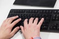 Young hacker typing code on computer keyboard Royalty Free Stock Photo