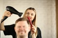 Young Hairdresser Drying Male Hair by Blow Dryer Royalty Free Stock Photo