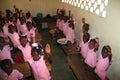 Young Haitian kindergarten school girls and boys show friendship bracelets in village.