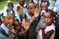 Young Haitian school children show friendship bracelets in village.