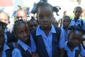 Young Haitian school girls curiously pose for camera in rural village.