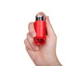 Hand holding inhaler facing viewer, isolated