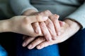 Young hand holding old hands of a woman Royalty Free Stock Photo