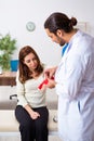 Young hand injured woman visiting male doctor traumatologist Royalty Free Stock Photo