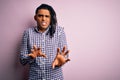 Young handsome african american afro man with dreadlocks wearing casual shirt disgusted expression, displeased and fearful doing Royalty Free Stock Photo