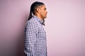 Young handsome african american afro man with dreadlocks wearing casual shirt looking to side, relax profile pose with natural Royalty Free Stock Photo