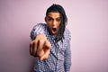 Young handsome african american afro man with dreadlocks wearing casual shirt pointing displeased and frustrated to the camera, Royalty Free Stock Photo