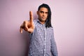 Young handsome african american afro man with dreadlocks wearing casual shirt Pointing with finger up and angry expression, Royalty Free Stock Photo