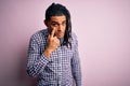 Young handsome african american afro man with dreadlocks wearing casual shirt Pointing to the eye watching you gesture, suspicious Royalty Free Stock Photo