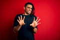 Young handsome african american afro man with dreadlocks wearing casual t-shirt disgusted expression, displeased and fearful doing Royalty Free Stock Photo