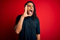 Young handsome african american afro man with dreadlocks wearing casual t-shirt shouting and screaming loud to side with hand on Royalty Free Stock Photo