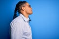 Young handsome african american man with dreadlocks wearing casual shirt and glasses looking to side, relax profile pose with Royalty Free Stock Photo