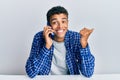 Young handsome african american man having conversation talking on the smartphone screaming proud, celebrating victory and success Royalty Free Stock Photo