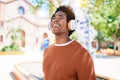 Young handsome african american man listening to music using headphones Royalty Free Stock Photo