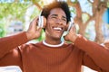 Young handsome african american man listening to music using headphones Royalty Free Stock Photo