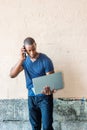 Young Handsome African American Man talking on cell phone outside in New York City Royalty Free Stock Photo