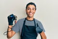 Young handsome african american man tattoo artist wearing professional uniform and gloves holding tattooer machine doing happy Royalty Free Stock Photo