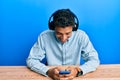 Young handsome african american man using smartphone wearing headphones smiling and laughing hard out loud because funny crazy Royalty Free Stock Photo