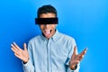 Young handsome african american man wearing banner glasses covering eyes celebrating victory with happy smile and winner