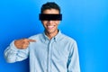 Young handsome african american man wearing banner glasses covering eyes pointing finger to one self smiling happy and proud