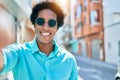 Young handsome african american man wearing casual clothes and sunglasses smiling happy Royalty Free Stock Photo