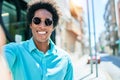 Young handsome african american man wearing casual clothes and sunglasses smiling happy Royalty Free Stock Photo