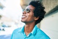 Young handsome african american man wearing casual clothes and sunglasses smiling happy Royalty Free Stock Photo