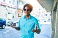 Young handsome african american man wearing casual clothes and sunglasses smiling happy Royalty Free Stock Photo