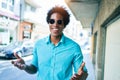 Young handsome african american man wearing casual clothes and sunglasses smiling happy Royalty Free Stock Photo