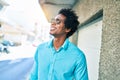 Young handsome african american man wearing casual clothes and sunglasses smiling happy Royalty Free Stock Photo