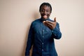 Young handsome african american man wearing casual shirt standing over white background smiling friendly offering handshake as Royalty Free Stock Photo