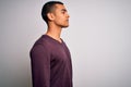 Young handsome african american man wearing casual sweater over white background looking to side, relax profile pose with natural Royalty Free Stock Photo