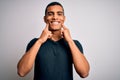 Young handsome african american man wearing casual t-shirt standing over white background Smiling with open mouth, fingers Royalty Free Stock Photo