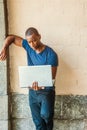 Young Handsome African American Man working on laptop computer outside in New York Royalty Free Stock Photo