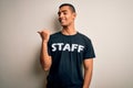 Young handsome african american worker man wearing staff uniform over white background smiling with happy face looking and Royalty Free Stock Photo