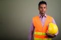 Young handsome African man construction worker against colored b Royalty Free Stock Photo