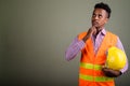 Young handsome African man construction worker against colored b Royalty Free Stock Photo