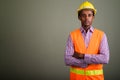 Young handsome African man construction worker against colored b Royalty Free Stock Photo