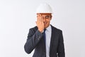 Young handsome architect man wearing suit and helmet over isolated white background covering one eye with hand, confident smile on Royalty Free Stock Photo