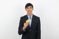 Young handsome asian business man holding credit card and looking to camera isolated on white background. Royalty Free Stock Photo