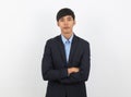 Young handsome asian business man looking to camera with arms crossed isolated on white background. Royalty Free Stock Photo