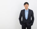 Young handsome asian business man looking to camera isolated on white background. Royalty Free Stock Photo