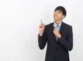 Young handsome asian business man pointing to the side with hand to present product Royalty Free Stock Photo