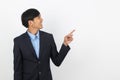 Young handsome asian business man pointing to the side with hand to present product Royalty Free Stock Photo