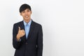 Young handsome asian business man smiling and showing thumbs up isolated on white background. Royalty Free Stock Photo
